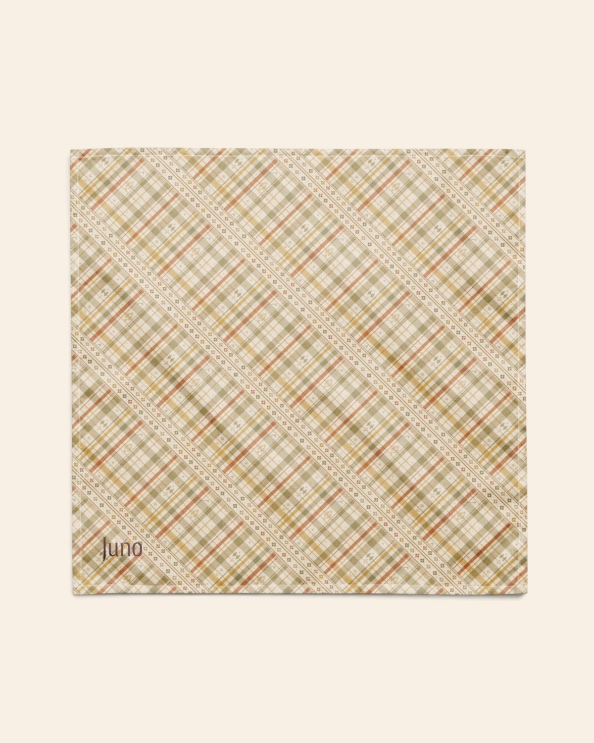 The bandana laid flat as a full square on a cream background, the print running on the diagonal. It is a sage, gold and apricot plaid on cream, banded with rows of small motifs, with the sample name Juno printed in the lower left corner.